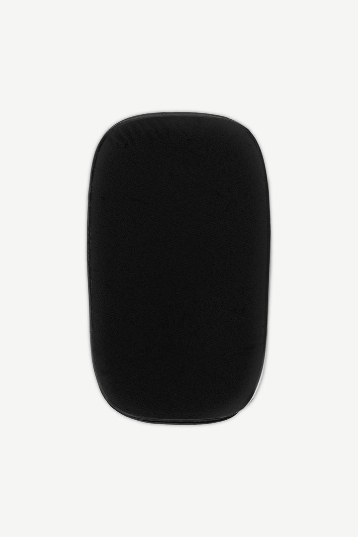 Black stick-on gel nail with matte finish and even surface texture, shown on white background.