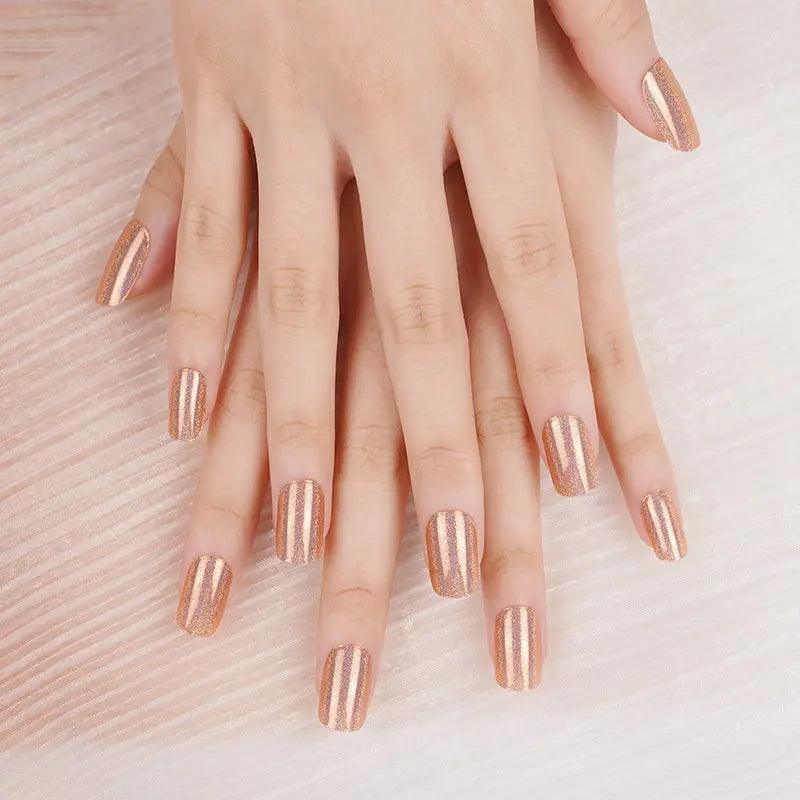 Rich amber gel nail wraps with iridescent shimmer and smooth metallic sheen on light skin tone under bright natural light.