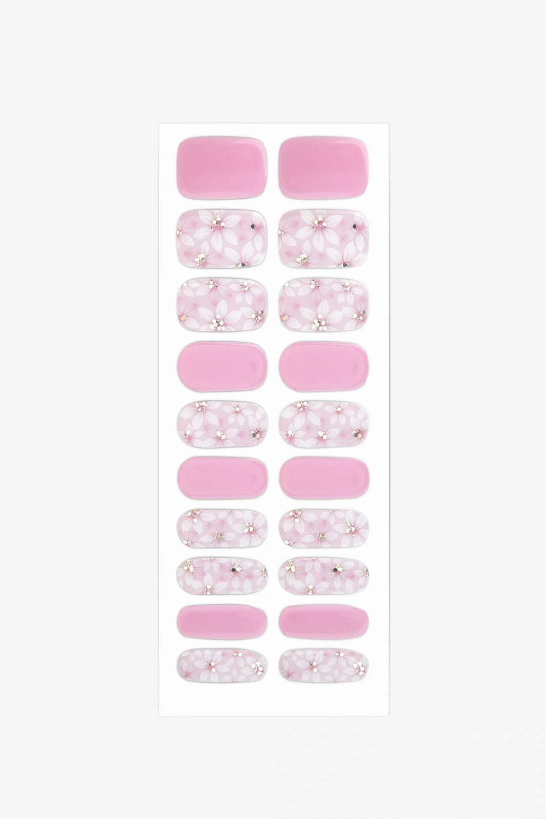 Sheet of semi-cured gel nail wraps in blush pink and white floral designs with golden accents and a glossy finish.