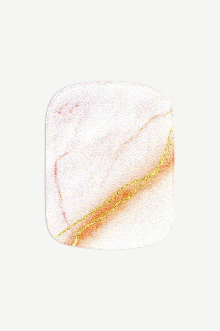 Macro image of a stick-on gel toenail with blush pink marble veining and delicate gold detailing, glossy finish on white background.