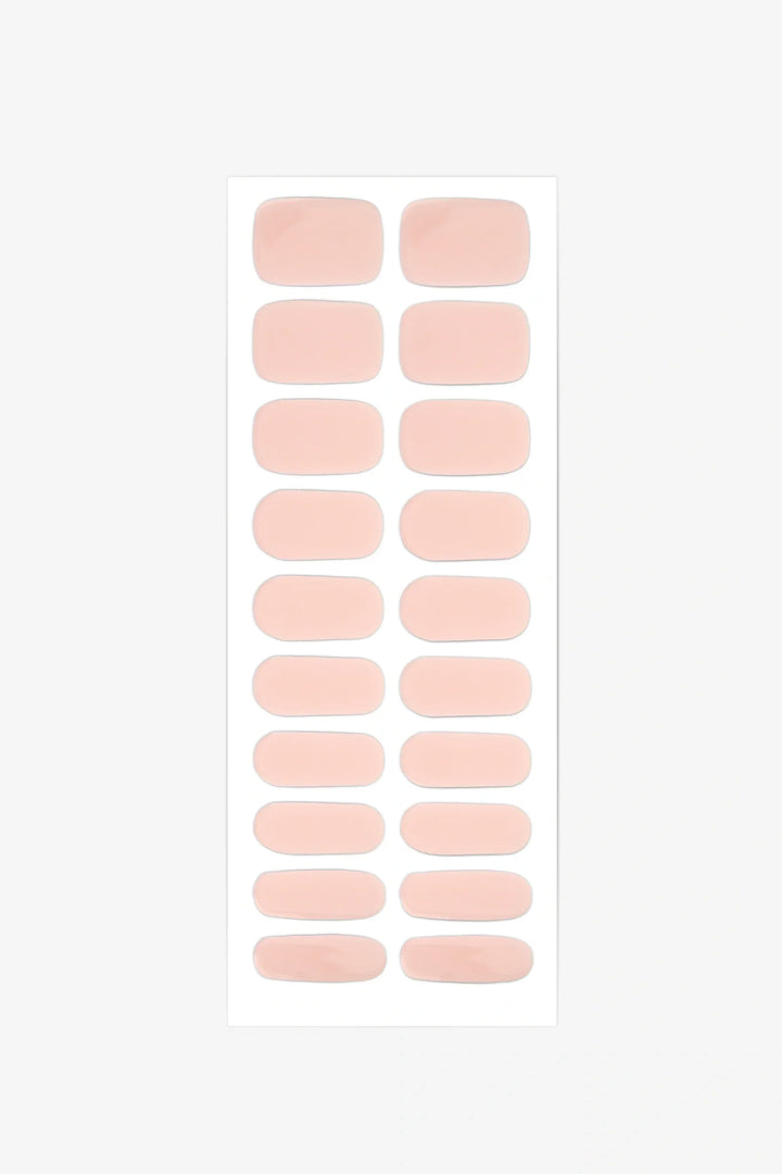 Sheet of semi-cured gel nail wraps in blush pink tones with a soft sheer texture and glossy surface.