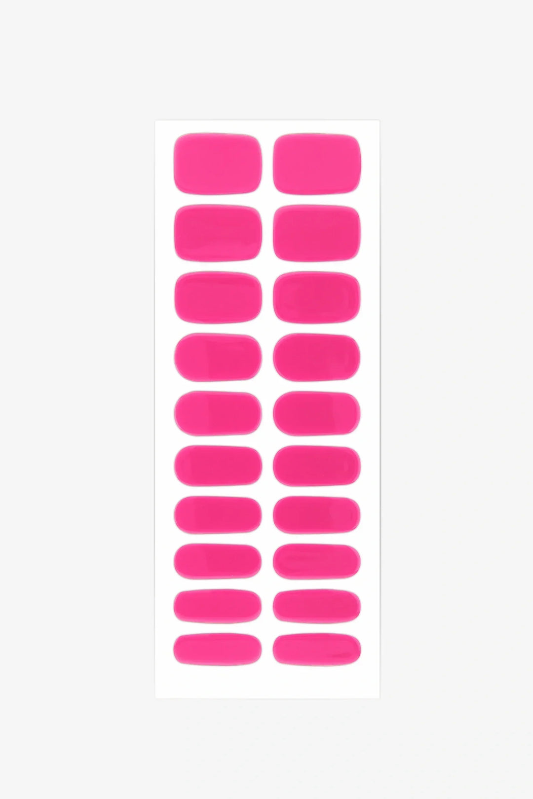 Sheet of bright pink semi-cured gel nail strips with vivid warm tone and glossy surface.