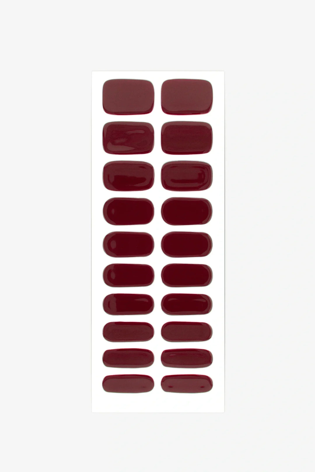Set of burgundy red gel nail strips arranged on a white background.