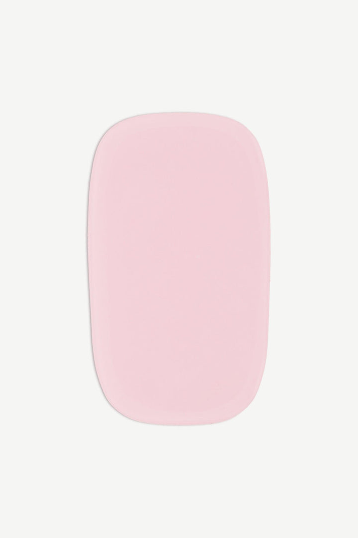 A close-up image of a single candyfloss pink stick-on gel nail with translucent finish and smooth glossy surface on white background.