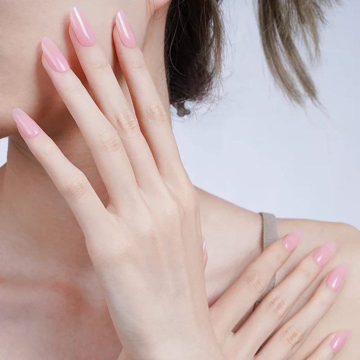 Semi-sheer candyfloss pink gel nail wraps with glossy finish on light skin tone, styled softly against a neutral background.
