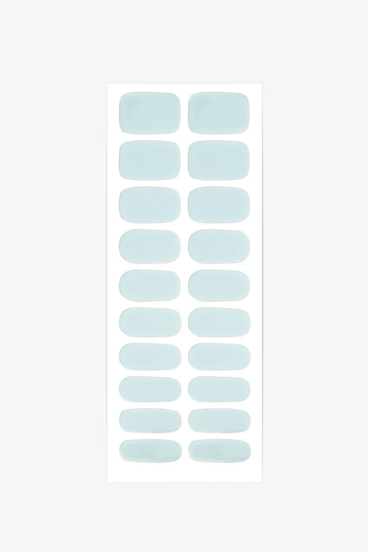 Sheet of semi-cured gel nail wraps in pale sea-foam teal shades with a smooth, high-gloss surface