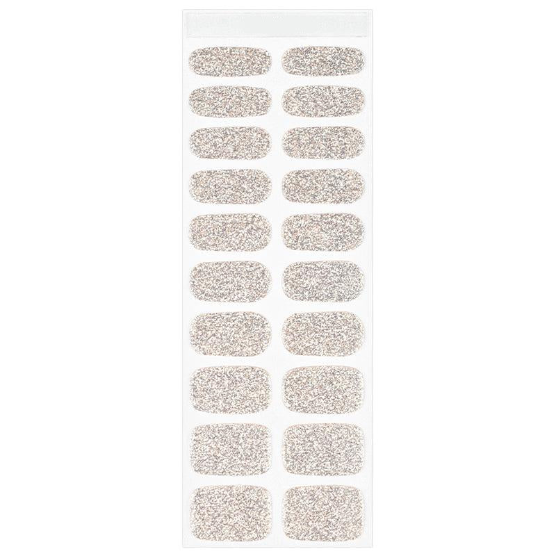 Sheet of champagne gold semi-cured gel nail strips with fine glitter and smooth glossy surface, displayed on white background.
