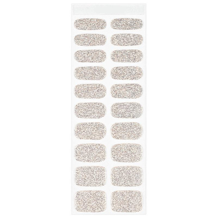 Sheet of champagne gold semi-cured gel nail strips with fine glitter and smooth glossy surface, displayed on white background.
