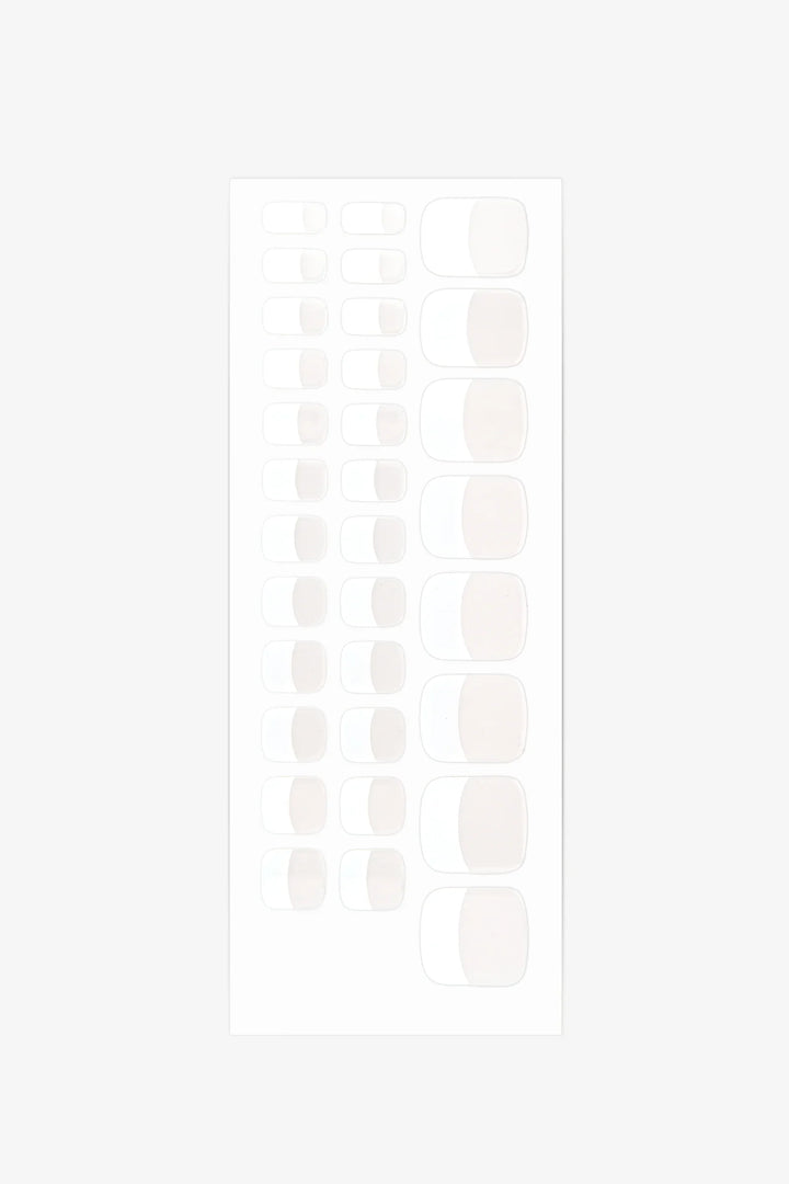 Sheet of French gel toenail wraps featuring sheer nude base and bright white tips with glossy finish.