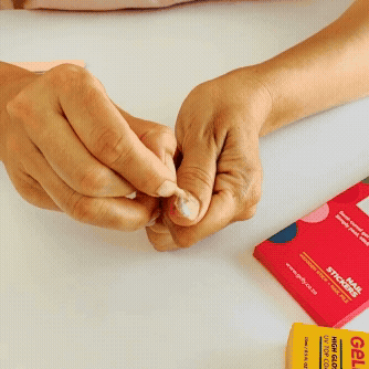 Animated GIF of a wooden stick lifting the edge of a semi-cured gel nail wrap for damage-free, easy removal.