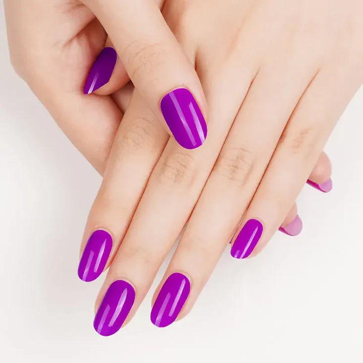 Bold fuchsia purple gel nail wraps with rich pigment, warm undertone, and ultra-glossy finish on light skin tone.