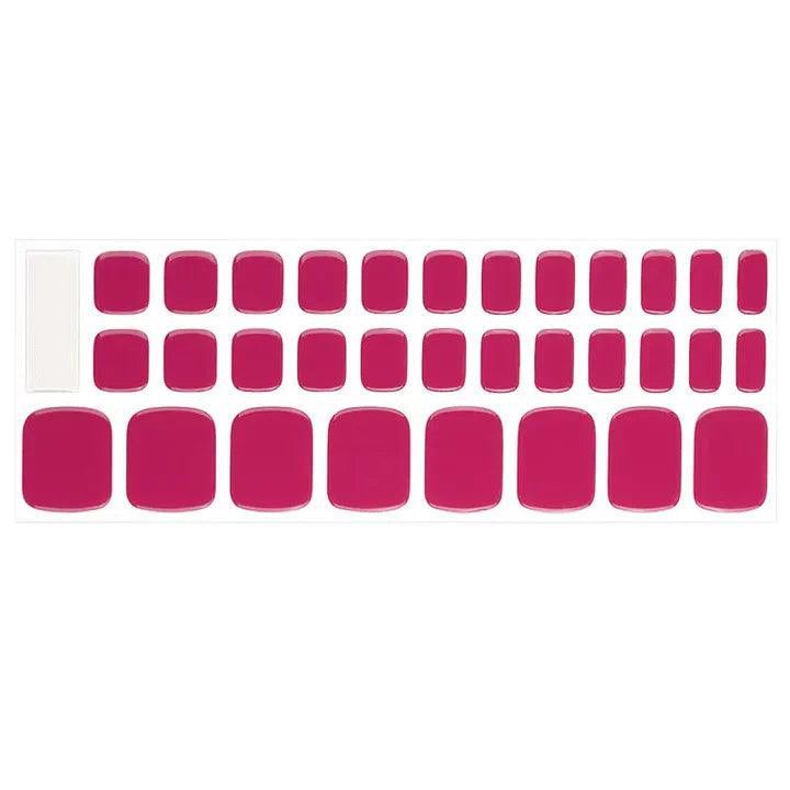 Sheet of bright pink semi-cured gel toenail strips with opaque color and high-gloss shine.