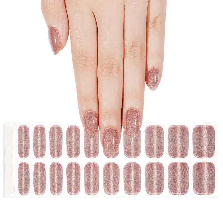 Sheet of rose gold cat-eye gel nail wraps with fine shimmer and smooth glossy surface.