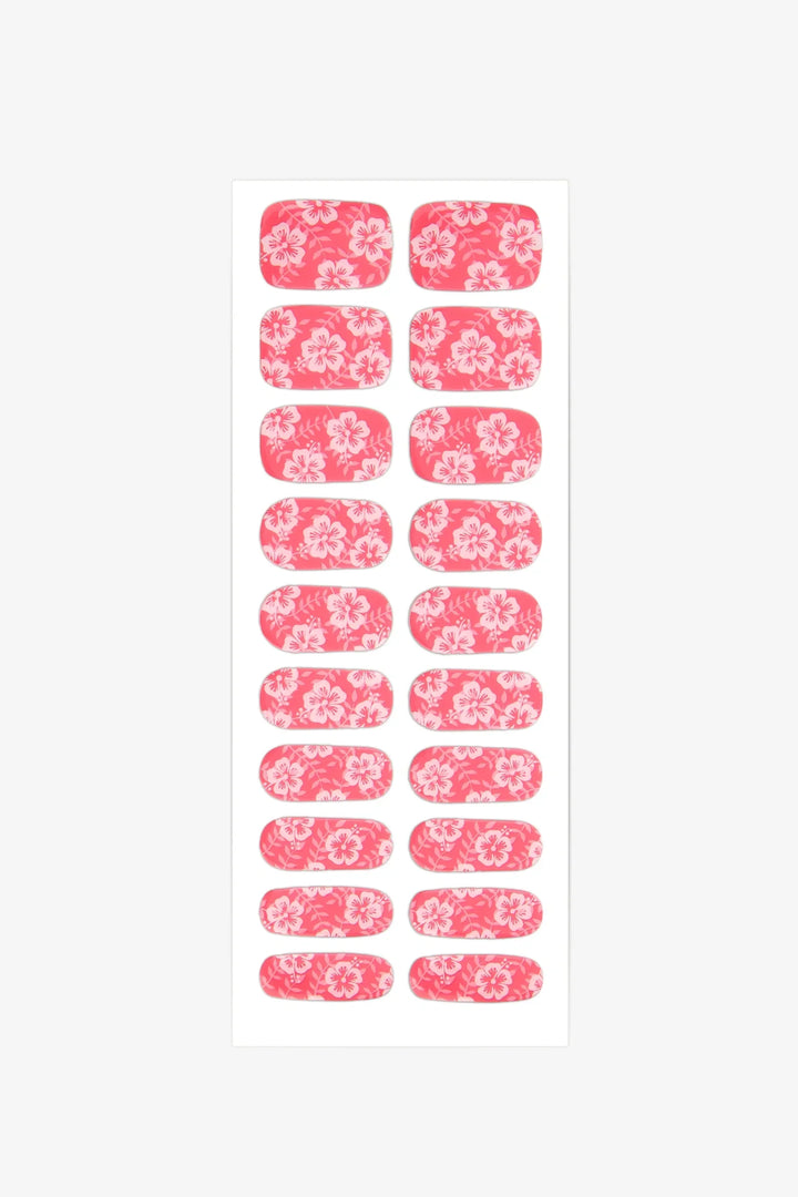 Sheet of semi-cured gel nail wraps in bright pink with white hibiscus designs and a smooth, glossy surface