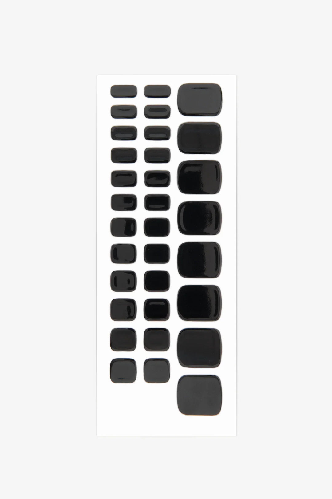 Sheet of black semi-cured gel toenail wraps with high-gloss finish and solid opaque color.