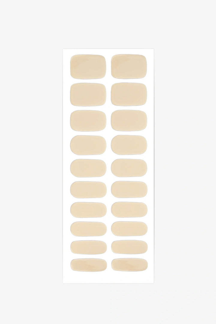 Sheet of semi-cured gel nail wraps in light pastel-yellow tones with a smooth, glossy finish.