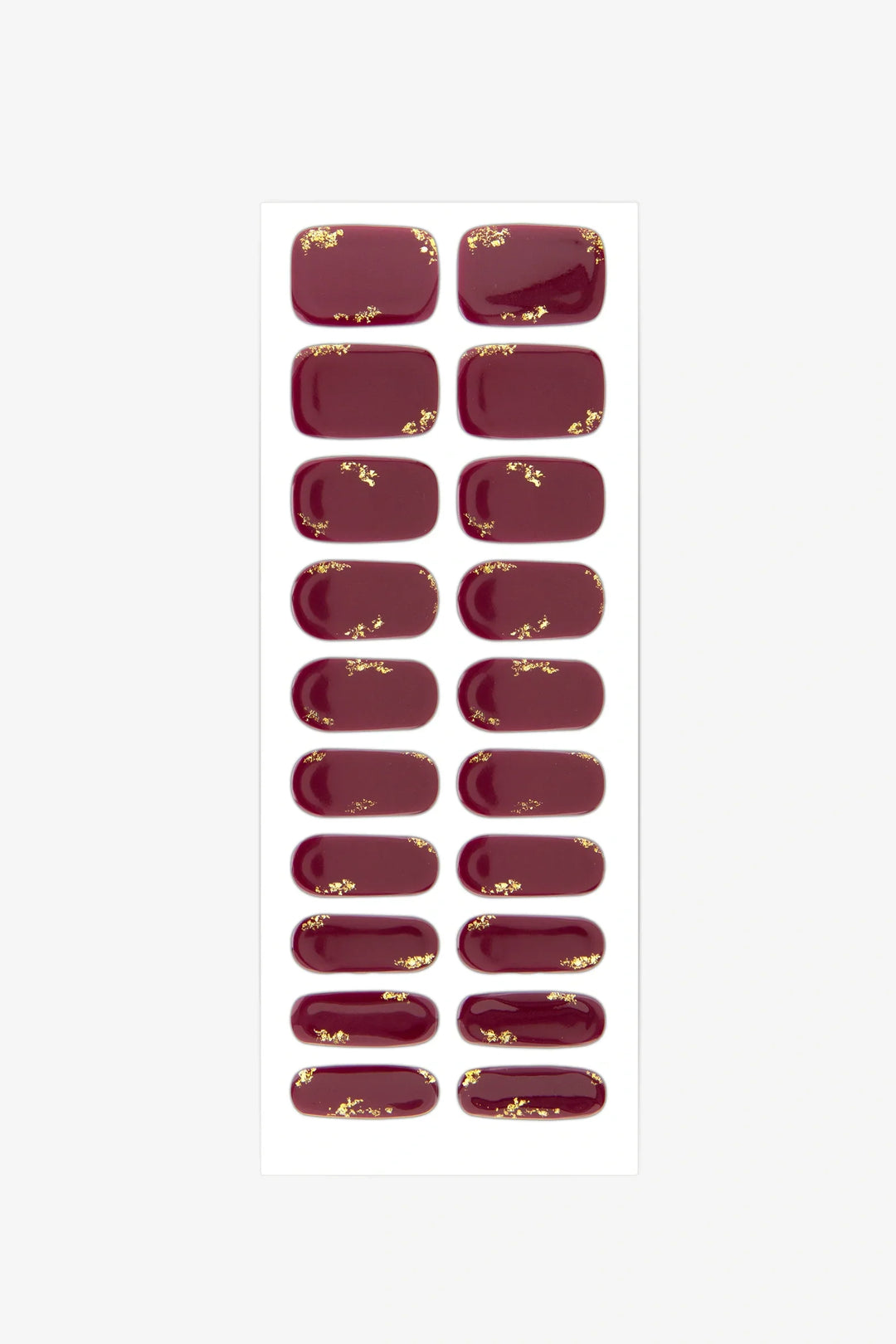 Sheet of semi-cured gel nail wraps in rich maroon with gold leaf detailing and a glossy surface.