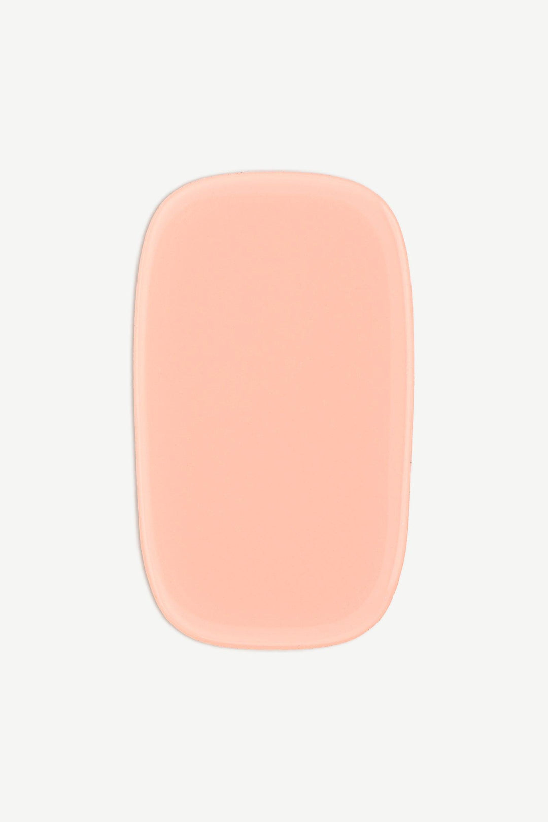 Close-up of a single nude peach stick-on gel nail wrap on a white background.