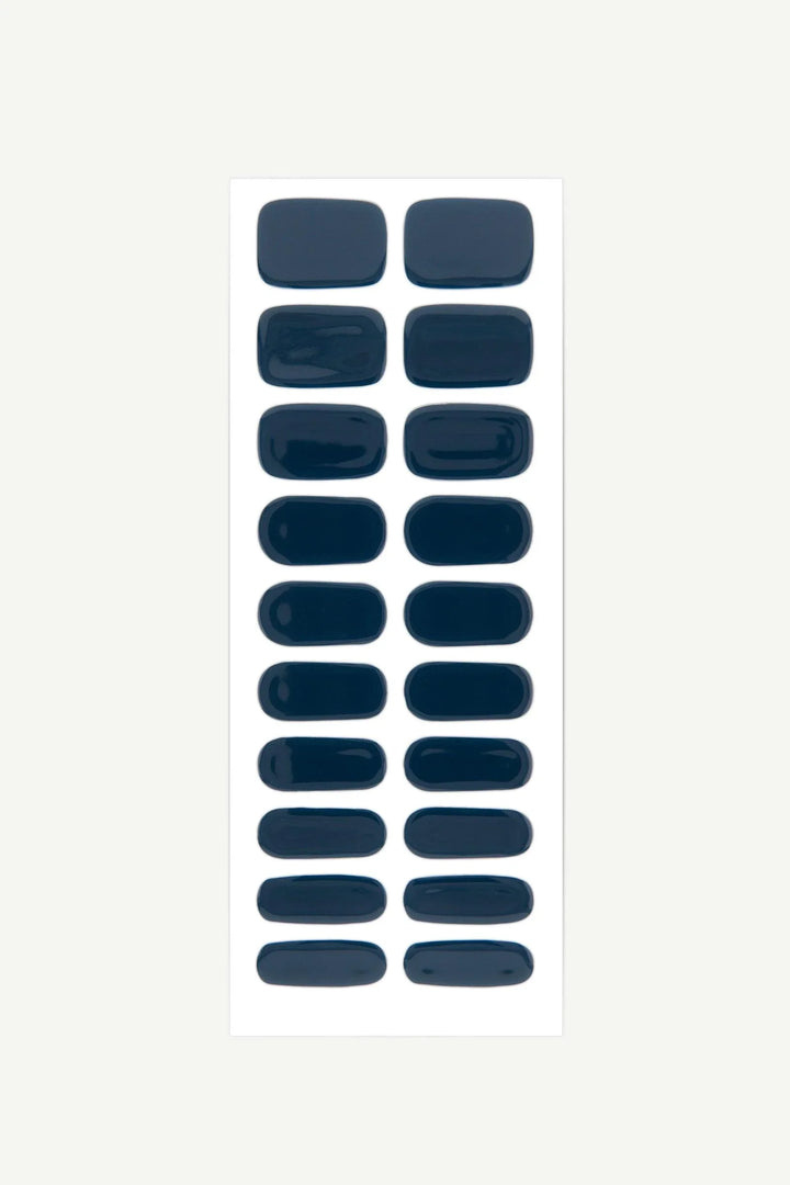 Sheet of dark navy blue semi-cured gel nail wraps with glossy finish.