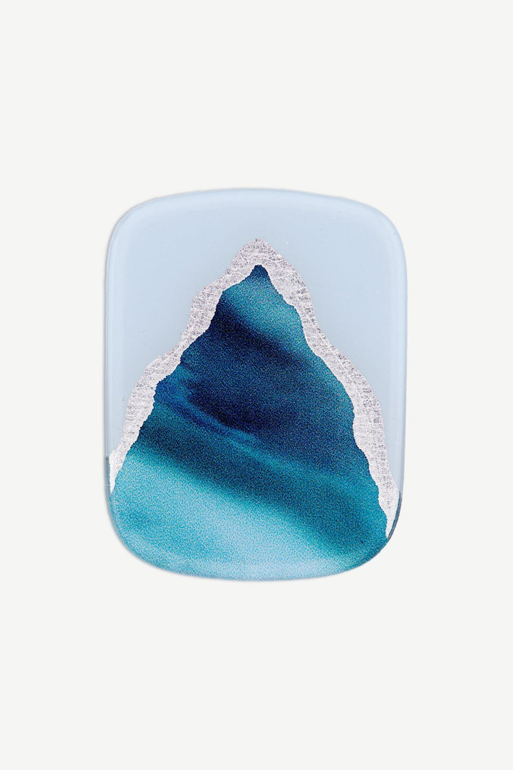 Macro image of an ocean blue marble gel toenail wrap with layered deep blue, aqua, and silver swirls.