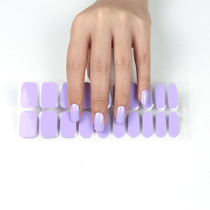 Medium-toned hand showing a full set of pastel lavender gel nail wraps.