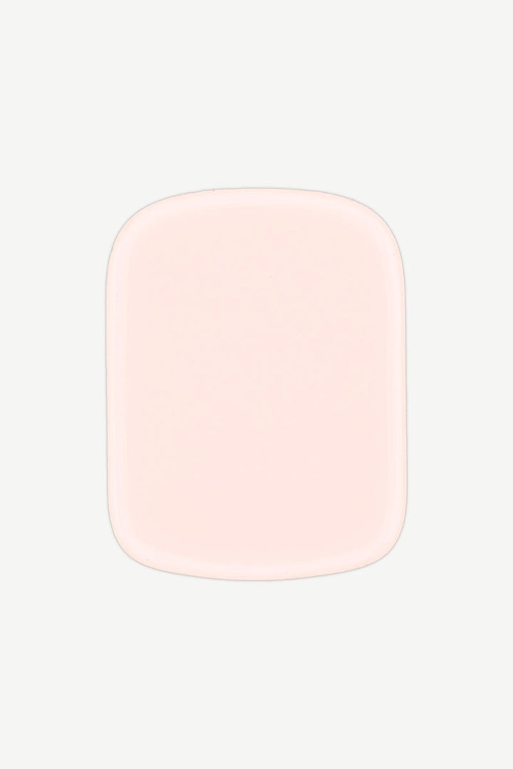 Close-up of a single creamy pastel pink stick-on gel nail with a high-gloss shine.