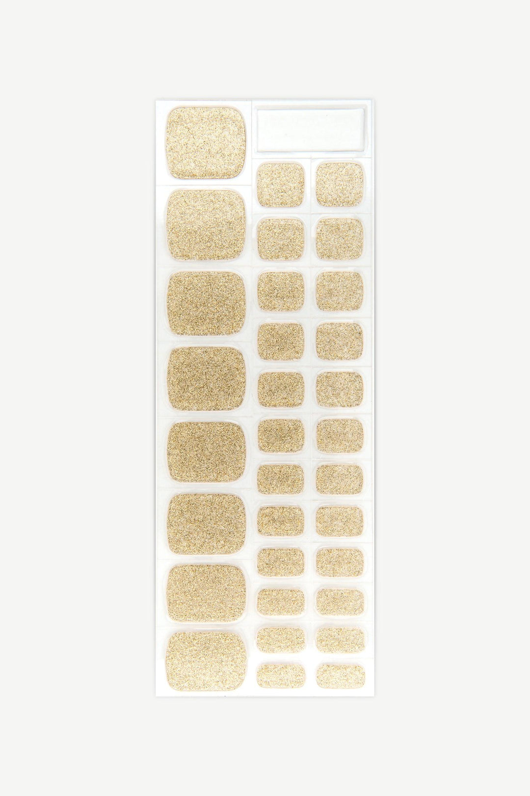 Sheet of shimmering gold semi-cured gel toenail wraps with fine sparkle and high-shine finish.