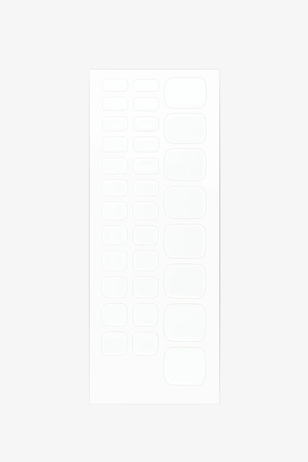 Sheet of solid white semi-cured gel toenail wraps with smooth glossy finish and full-coverage design.