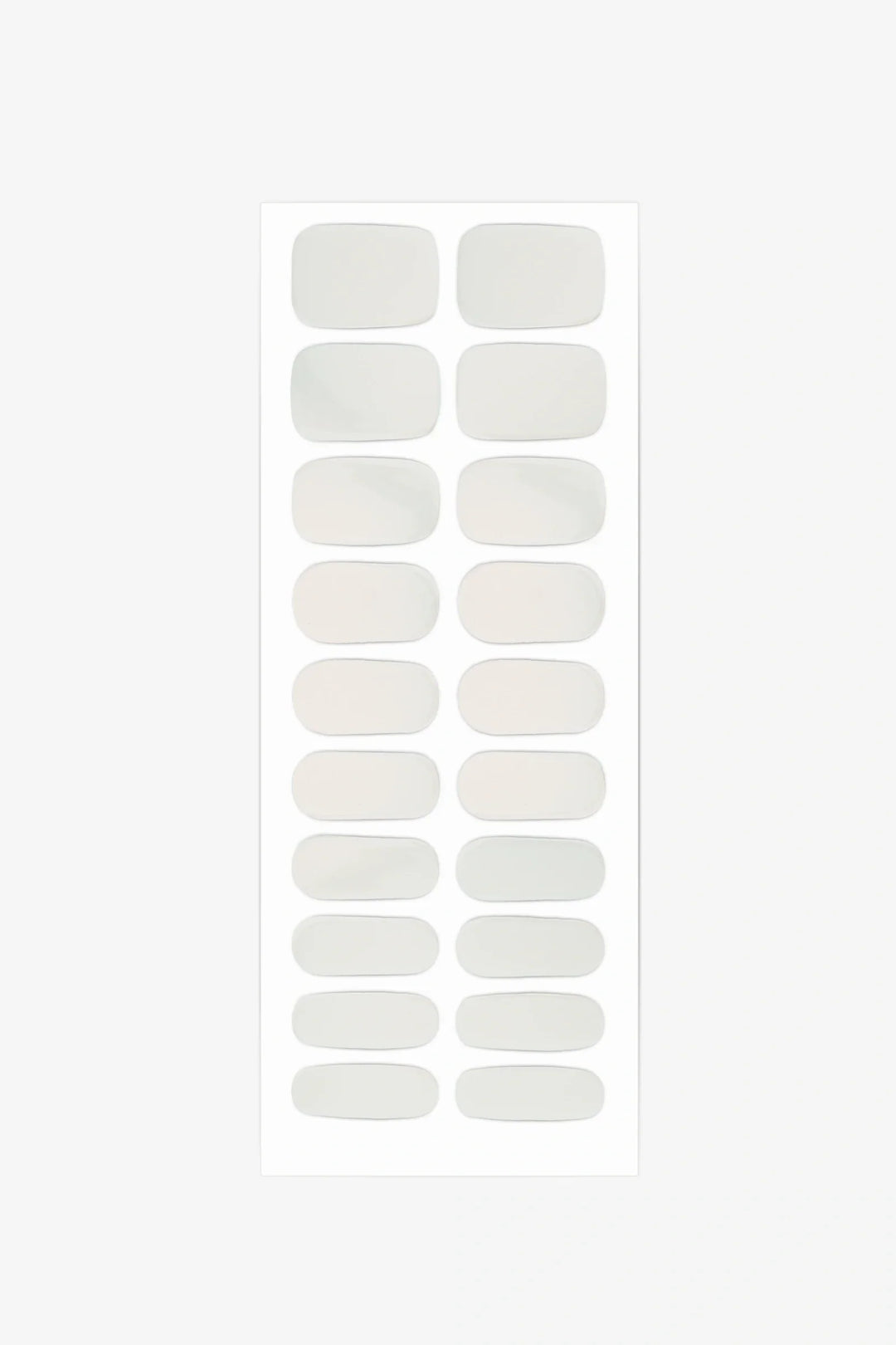 Sheet of semi-cured gel nail wraps featuring milky nude-beige shades that shift between ivory and warm peach.