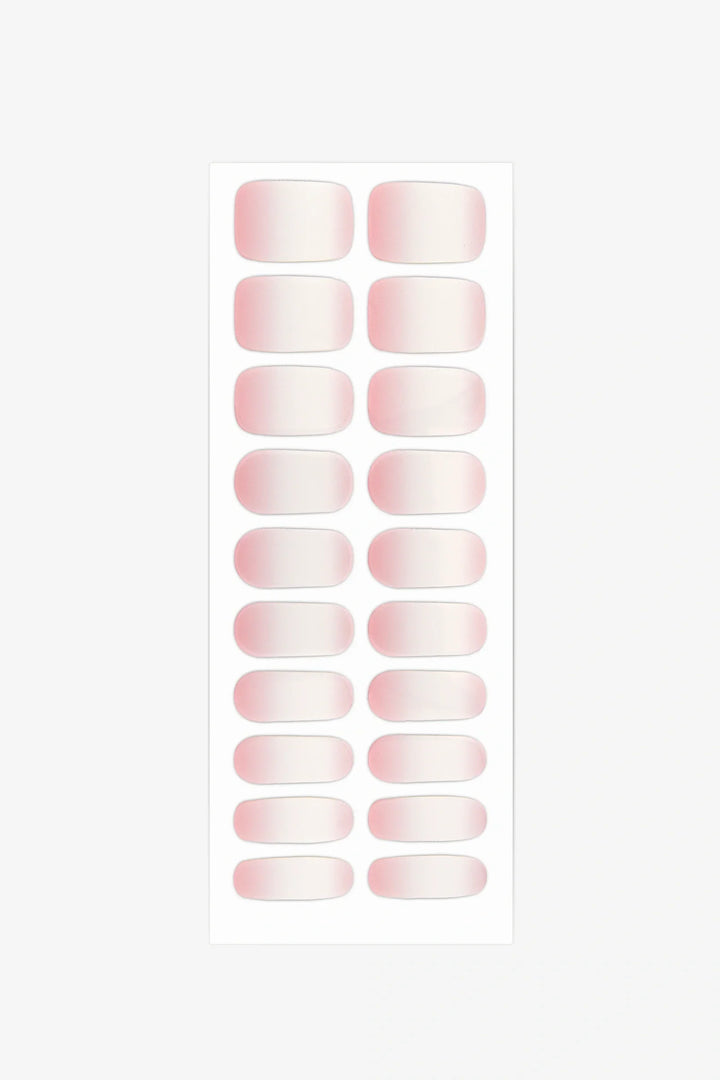 Full sheet of Baby Boomer gel nail wraps in a milky white to blush pink gradient, displayed in various sizes on a white background.