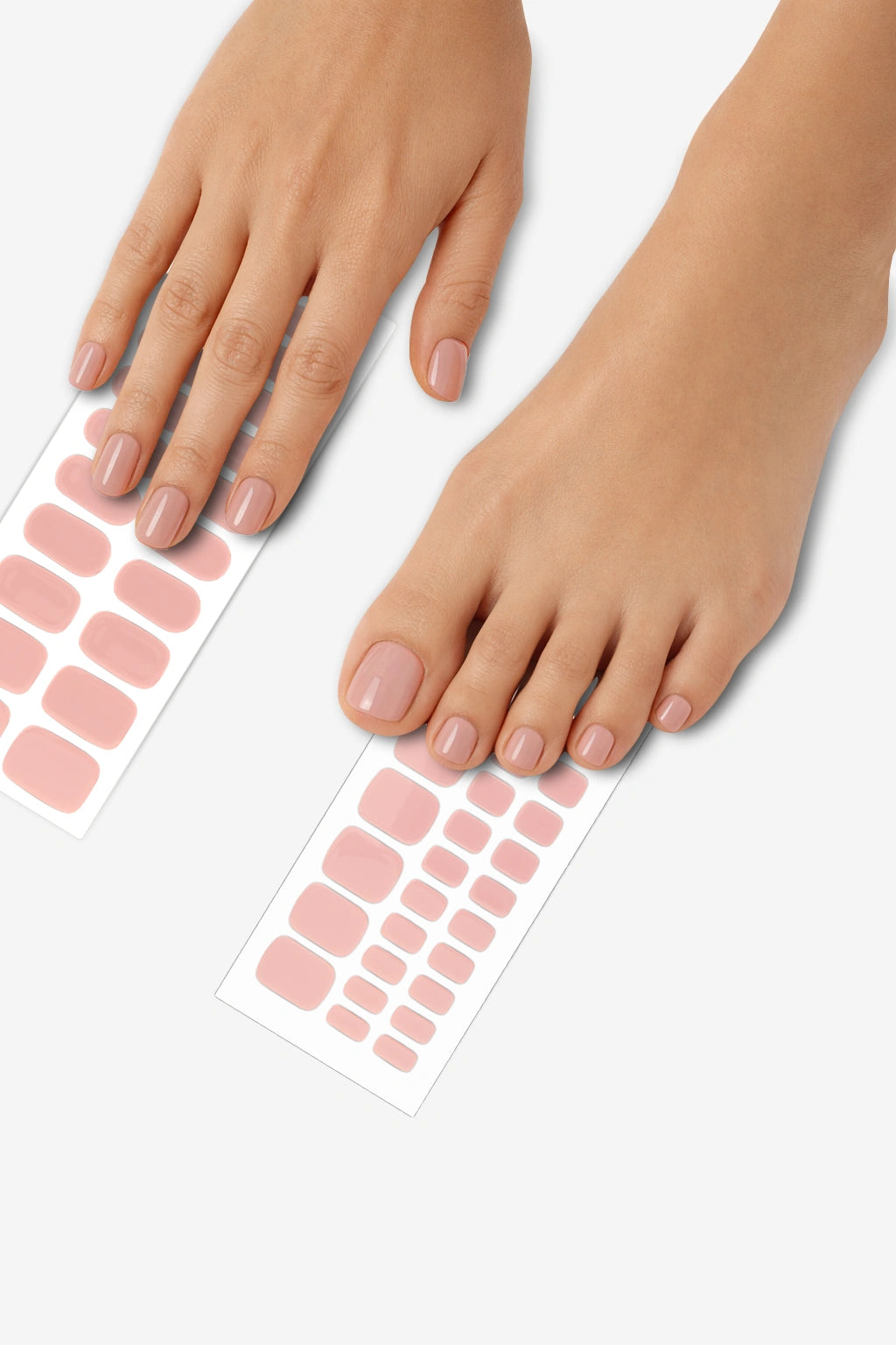 Barefoot semi-cured gel nail wrap mani and pedi bundle applied on hands and feet, featuring a glossy soft blush finish with matching wrap sheets displayed underneath.