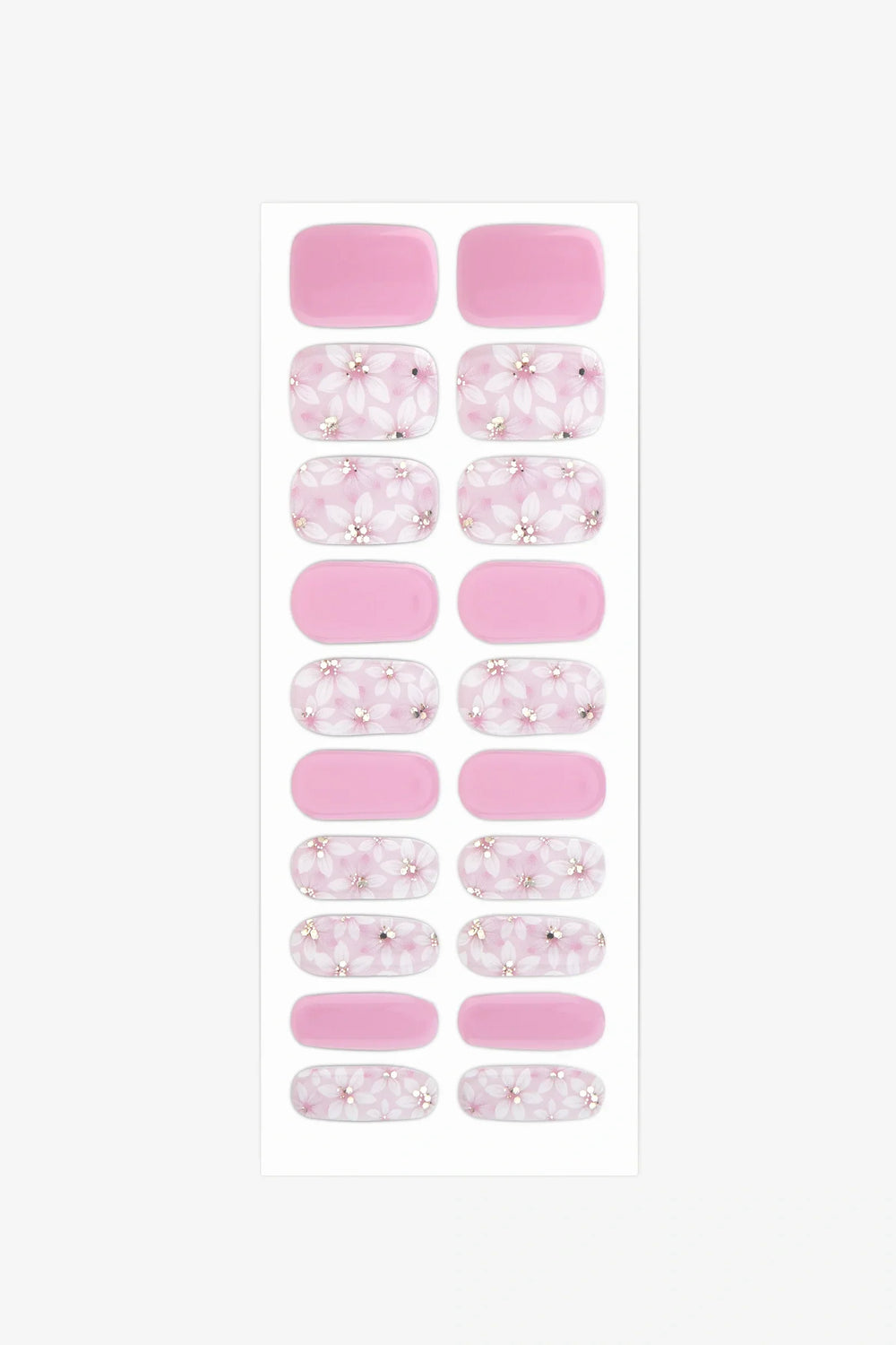 Sheet of semi-cured gel nail wraps in blush pink and white floral designs with golden accents and a glossy finish.