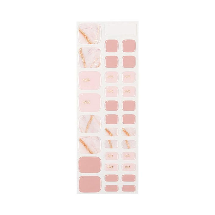 Sheet of blush pink semi-cured gel toenail strips with marble and gold accents in glossy finish, displayed on white background.