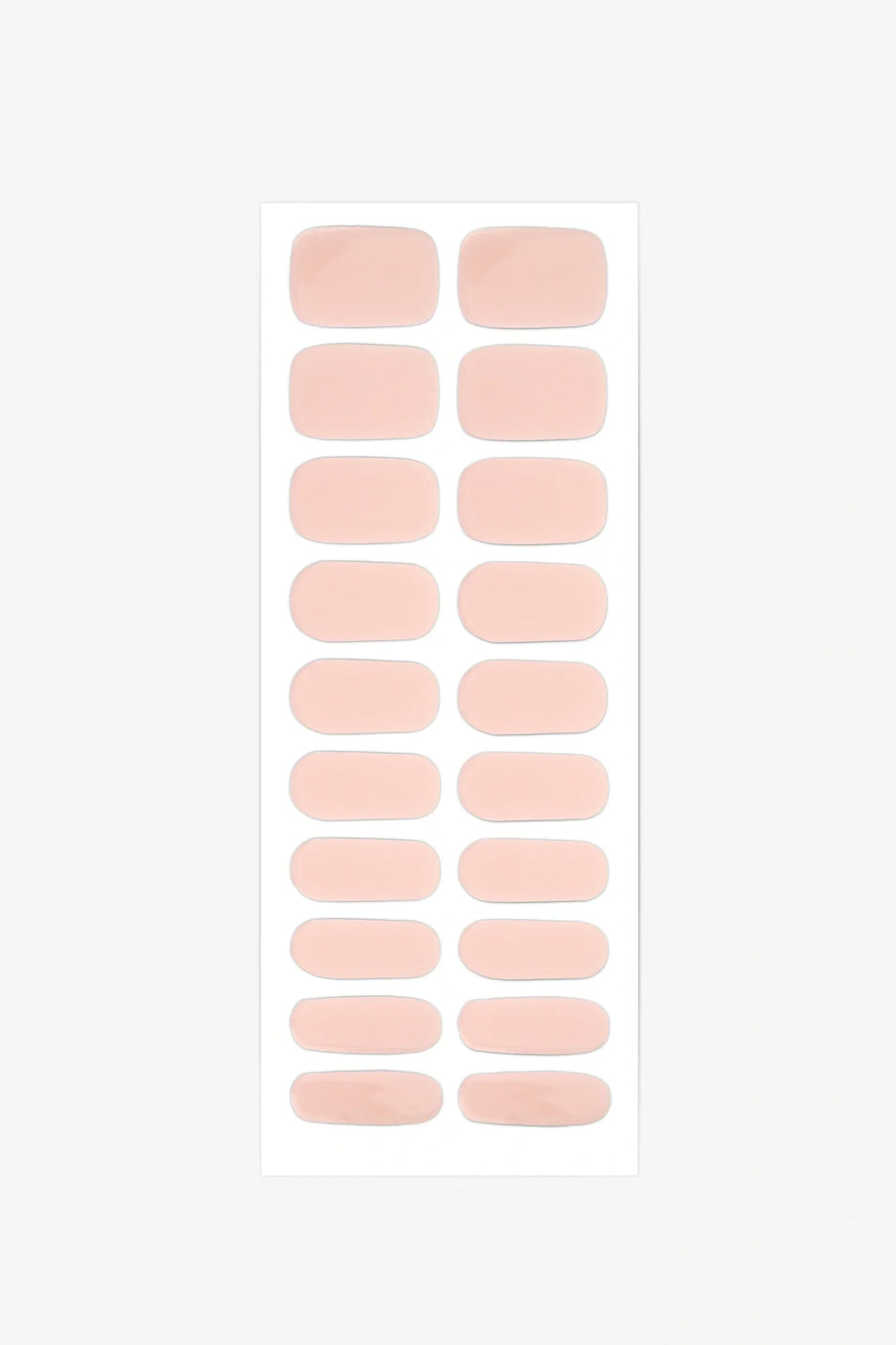 Sheet of semi-cured gel nail wraps in blush pink tones with a soft sheer texture and glossy surface.