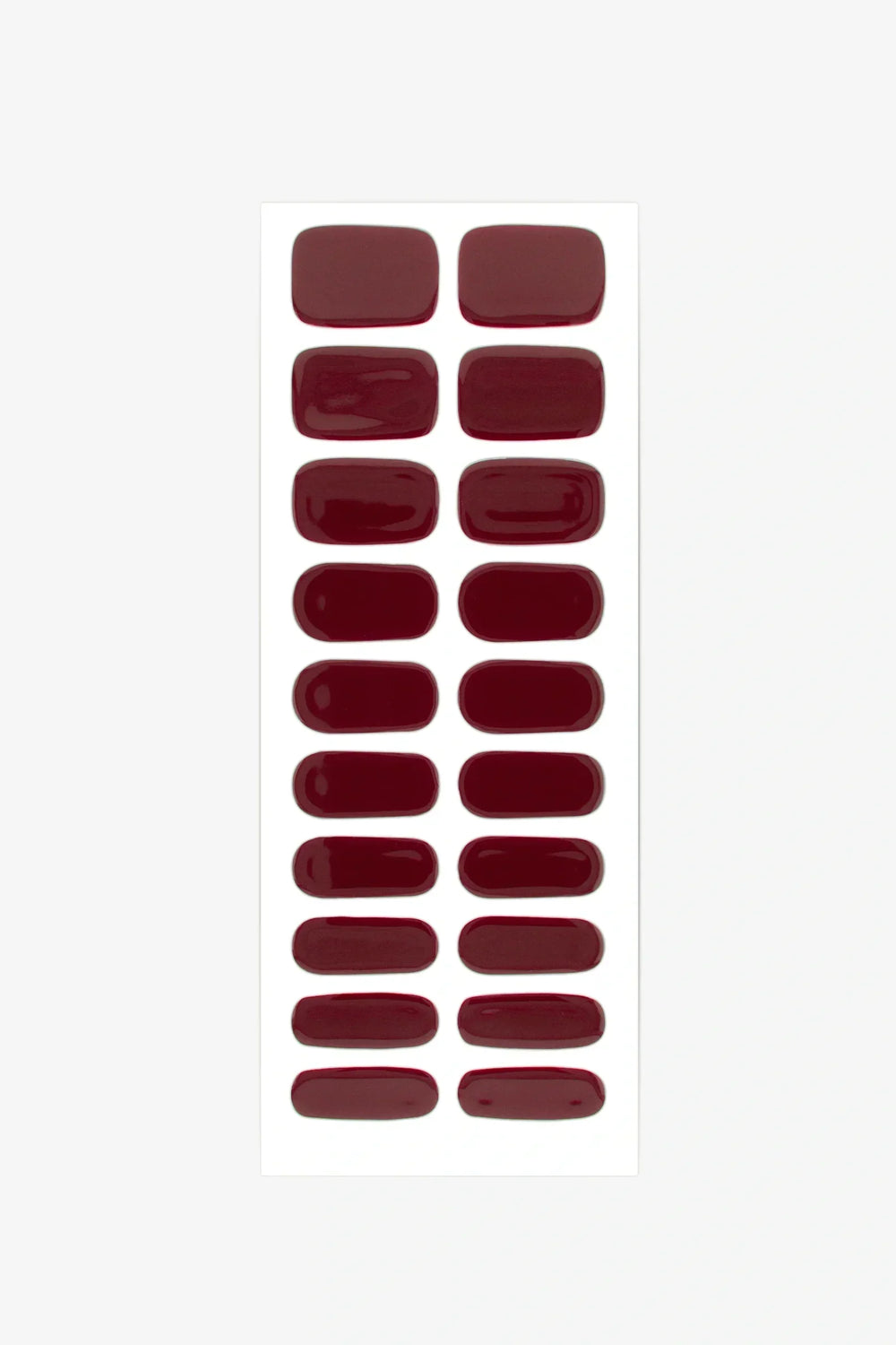 Set of burgundy red gel nail strips arranged on a white background.