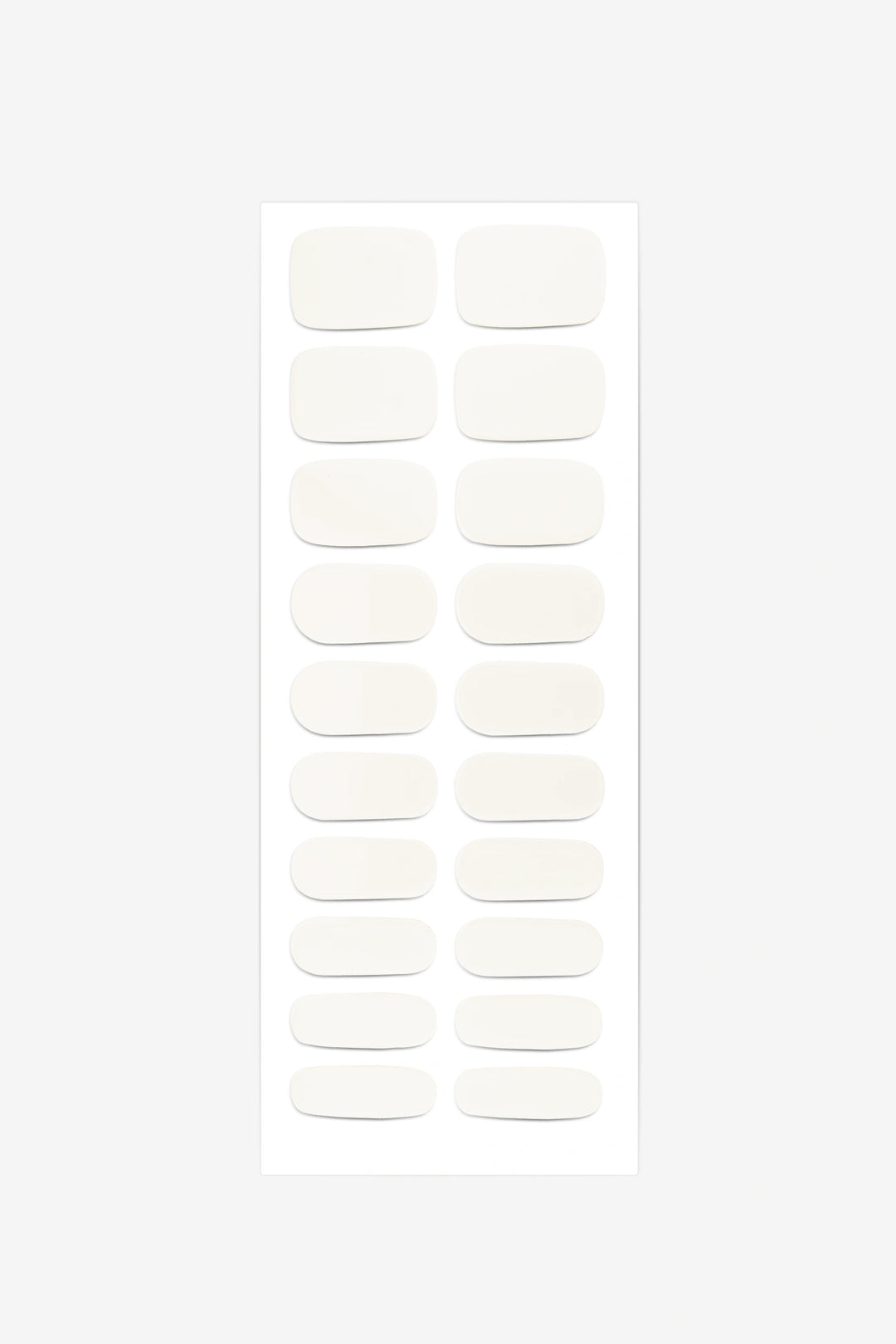 Full sheet of Creamy White semi-cured gel nail stickers displaying various sizes on a white background.