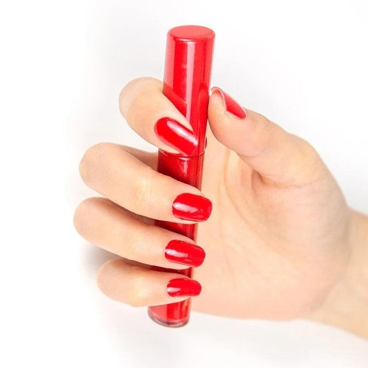 Light-skinned hand with bold red glossy gel nails.
