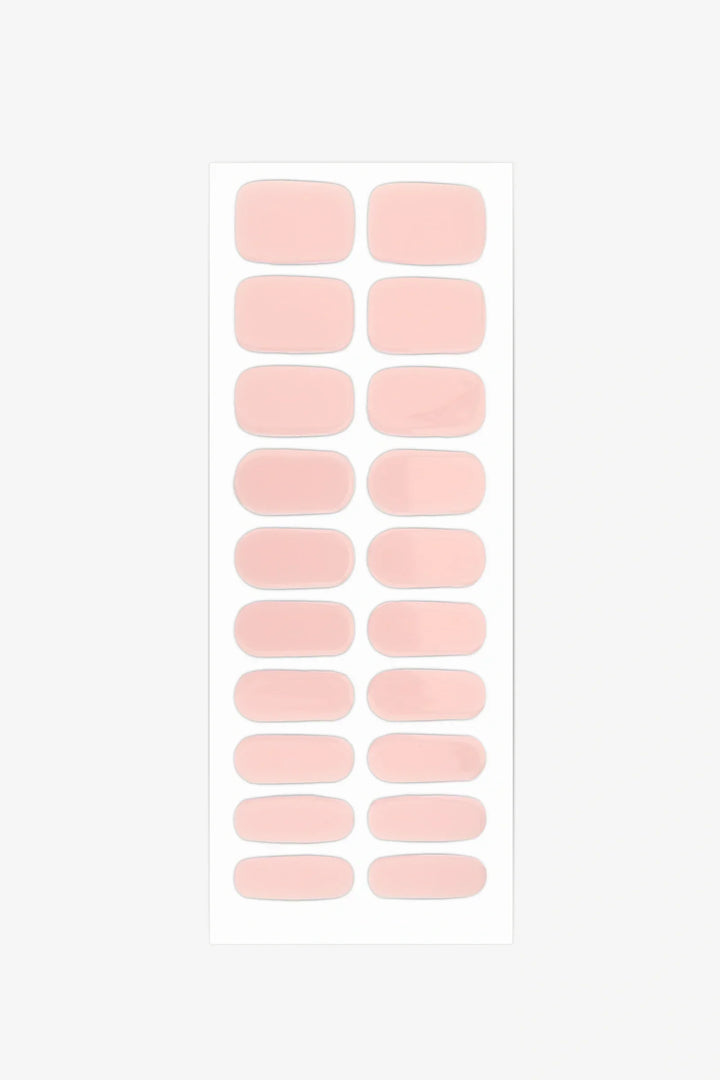 Full sheet of Dawn gel nail wraps in semi-transparent, blush pink with a soft rose tint and glossy finish, displayed in various sizes on a white background.