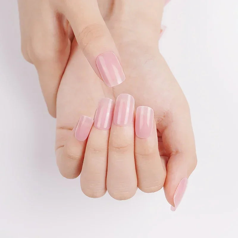 Hands with Dawn gel nail wraps in translucent blush pink, highlighting the glossy rose tint and luminous shine.