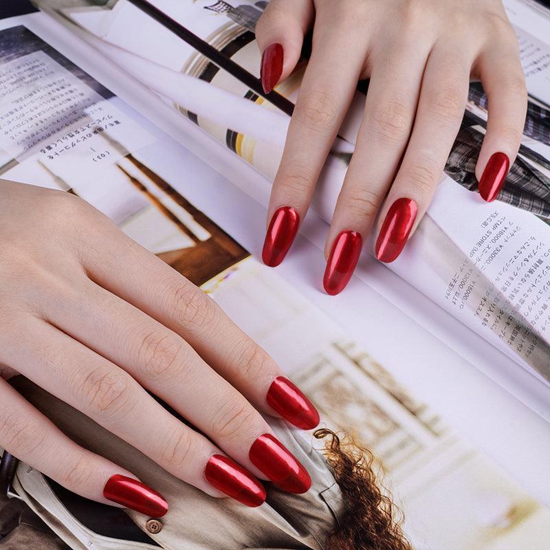 Fiery red semi-cured gel nail wraps with metallic reflection and glossy, semi-sheer surface on light skin tone.