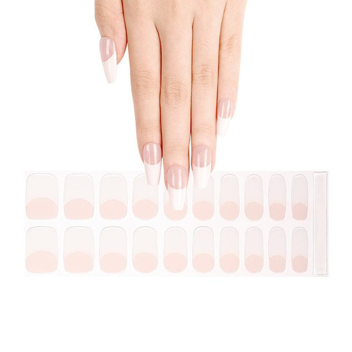 Sheet of French tip gel nail strips with nude base and white tips, shown on light skin tone under neutral studio light.  