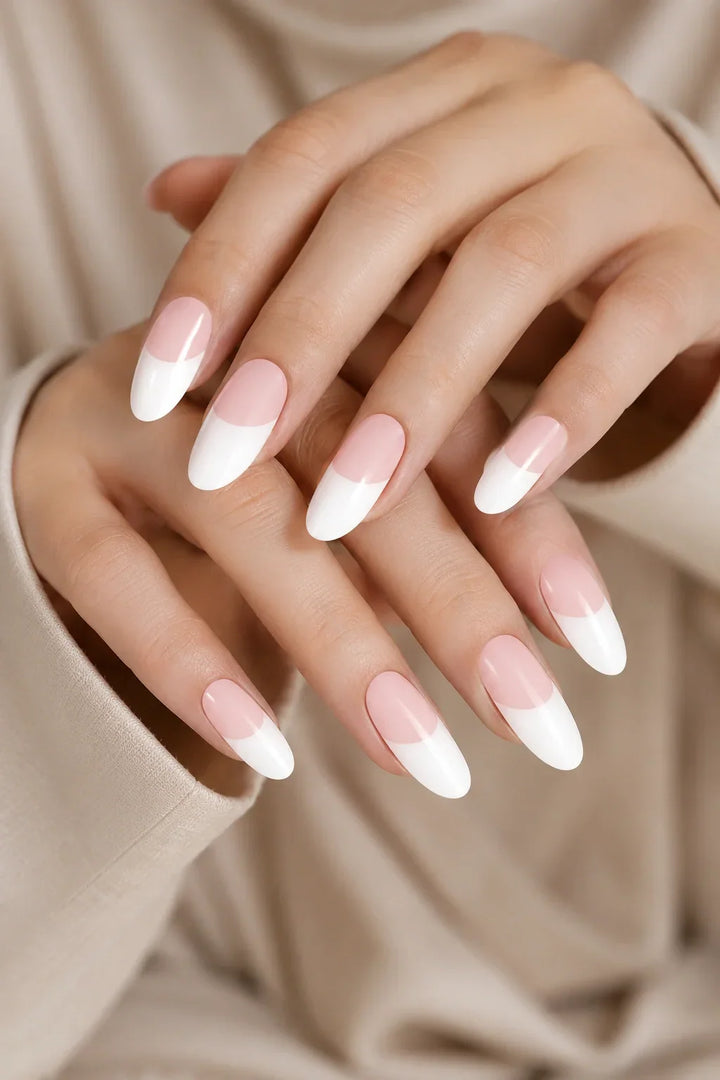 French Tips UV-free gel nail wraps featuring soft blush pink bases with crisp white tips and a glossy finish, shown on light skin.