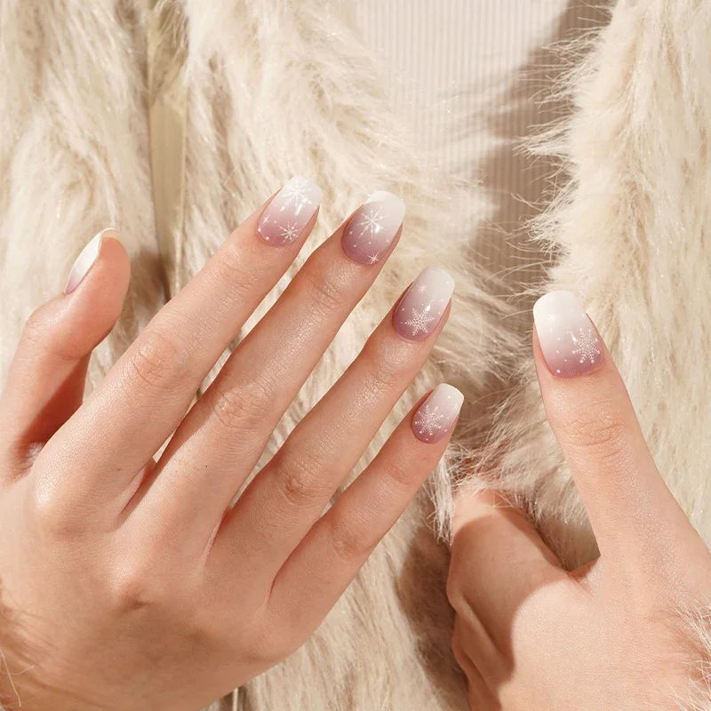 Frosted Boomer semi-cured gel nail stickers featuring a white-to-mauve ombré and snowflake design, shown under soft studio lighting on light skin with a cream faux-fur jacket.