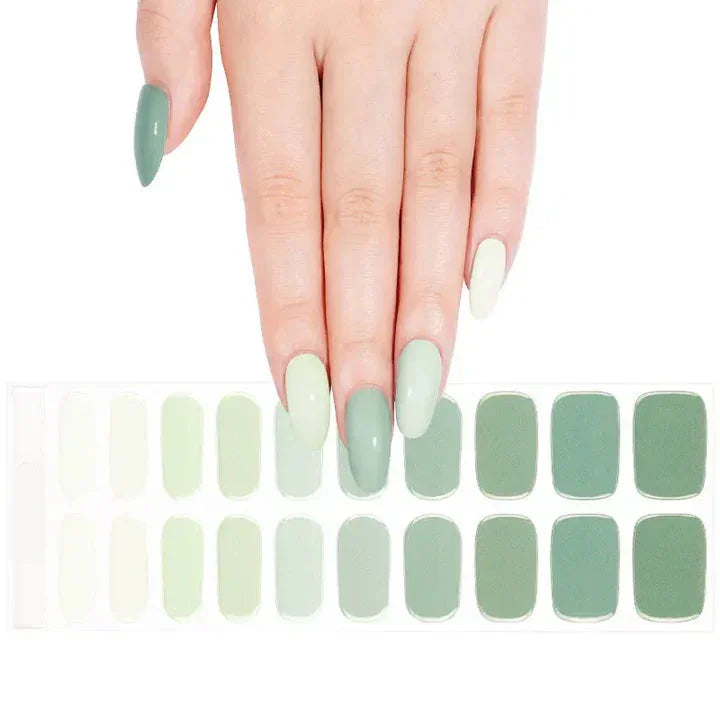 Sheet of gradient green gel nail wraps with glossy finish in mint, sage, and moss tones