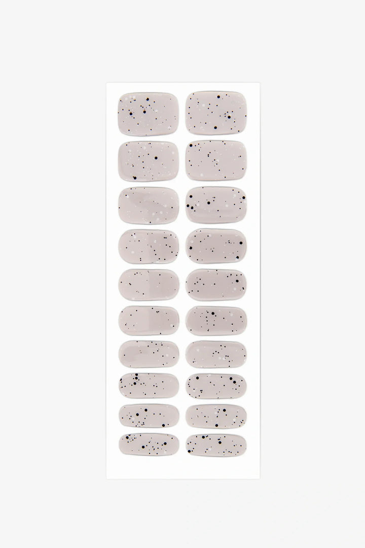 Full sheet of Gray Speckled Eggs gel nail wraps in light grey with fine black speckles, displayed in various sizes on a white background.