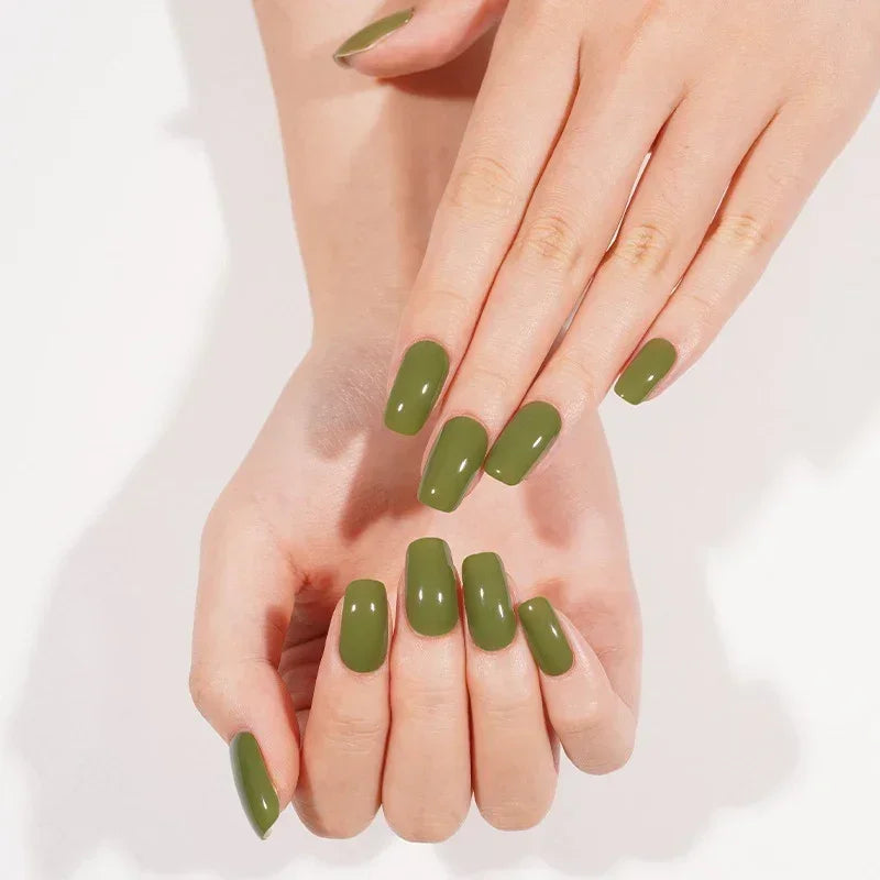Semi-cured gel nail wraps in earthy olive green with a creamy, reflective gloss, shown on light-medium skin.