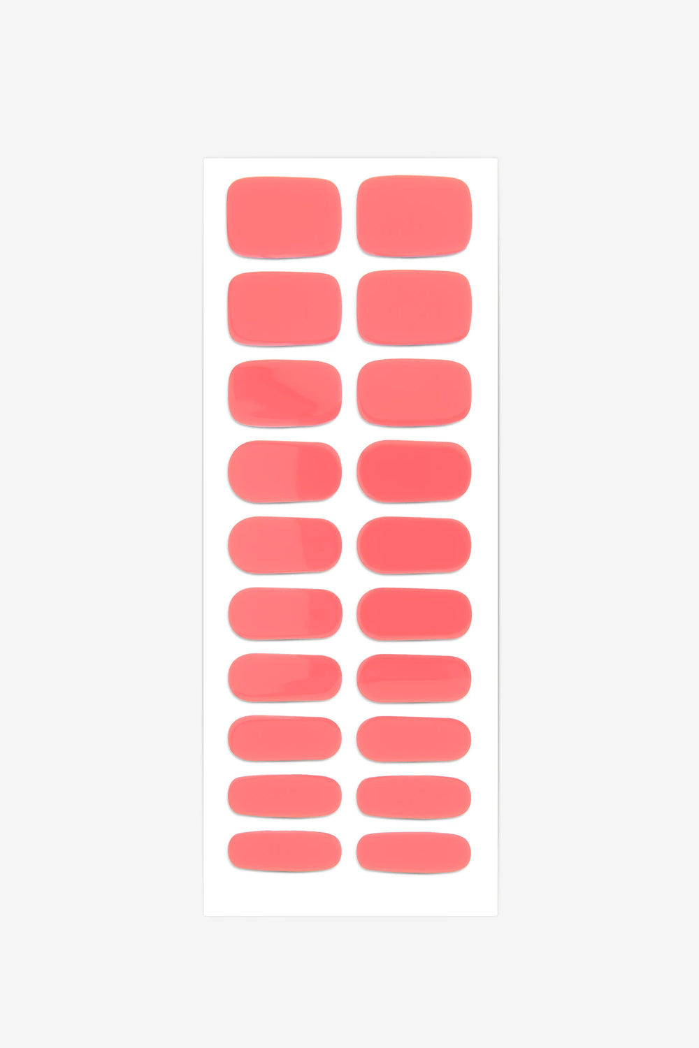 Guava UV-free gel nail wraps in a warm coral pink, shown as a full set of nail strips in assorted sizes.