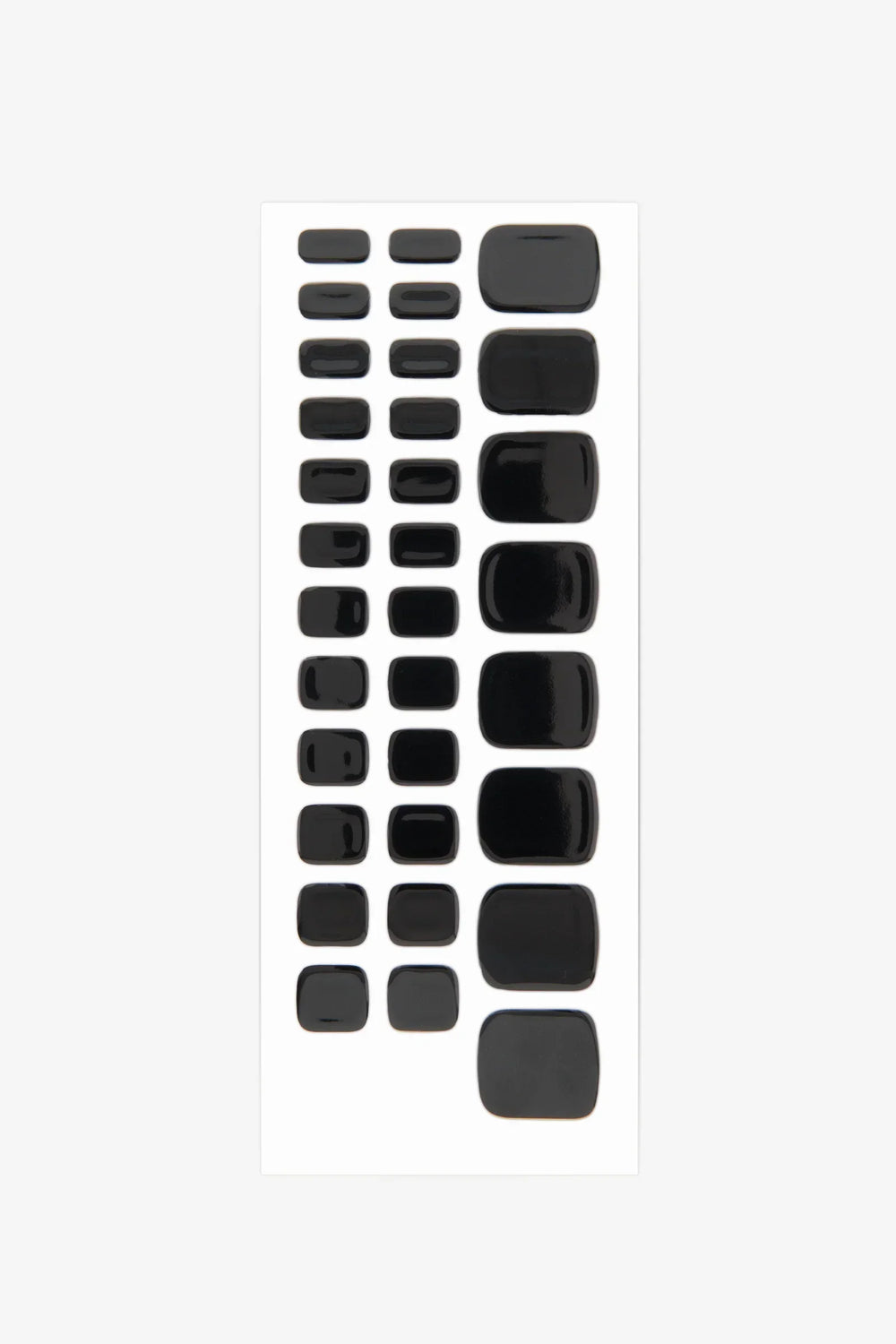 Sheet of black semi-cured gel toenail wraps with high-gloss finish and solid opaque color.