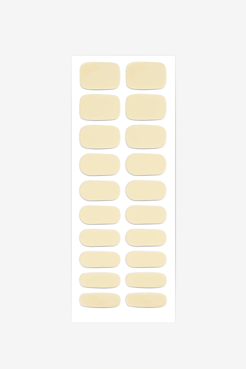 Sheet of semi-cured gel nail wraps in light pastel-yellow tones with a smooth, glossy finish.