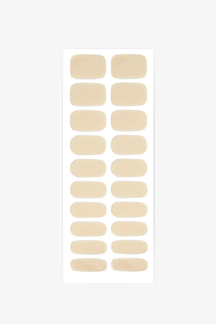 Sheet of semi-cured gel nail wraps in light pastel-yellow tones with a smooth, glossy finish.